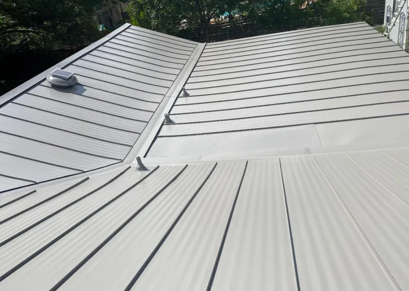 Solar attic fan installed on a metal roof for Roof Ventilation in Lehigh Acres